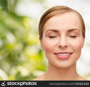 health and beauty concept - closeup of face of beautiful young woman with closed eyes