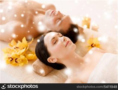 health and beauty concept - couple in spa salon lying on the massage desks
