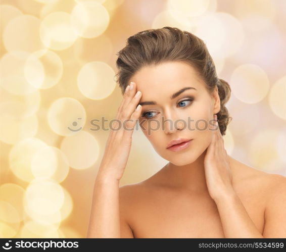 health and beauty concept - depressed woman holding hands on her neck and forehead