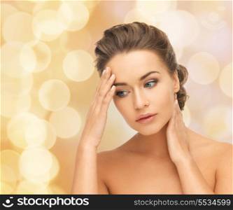 health and beauty concept - depressed woman holding hands on her neck and forehead