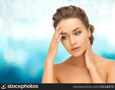 health and beauty concept - depressed woman holding hands on her neck and forehead
