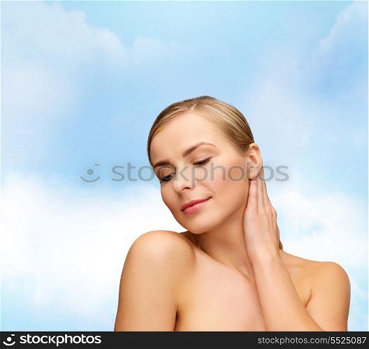 health and beauty concept - face and hands of beautiful woman