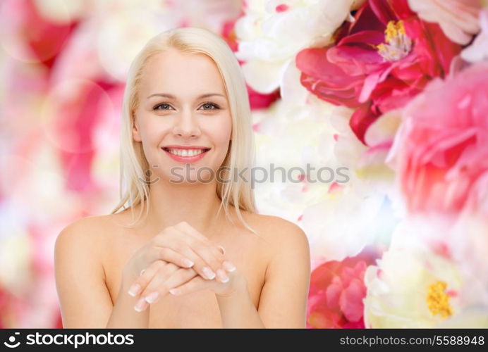 health and beauty concept - face and hands of beautiful woman