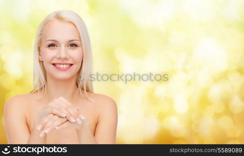 health and beauty concept - face and hands of beautiful woman