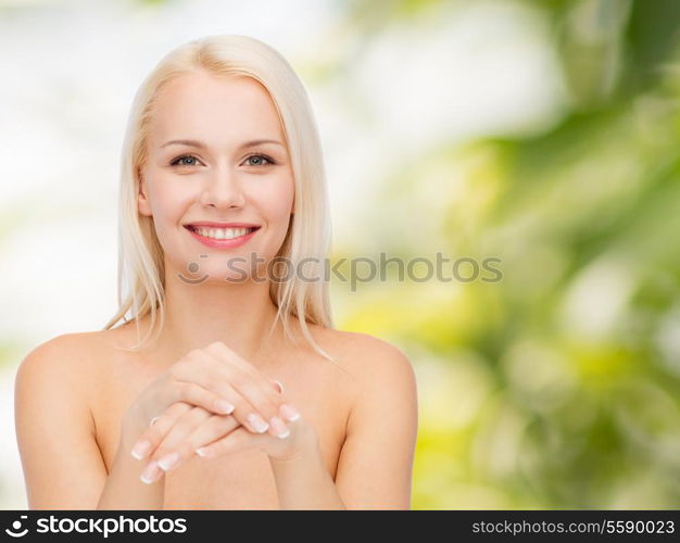 health and beauty concept - face and hands of beautiful woman