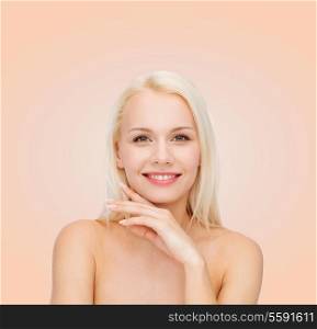 health and beauty concept - face and hands of beautiful woman