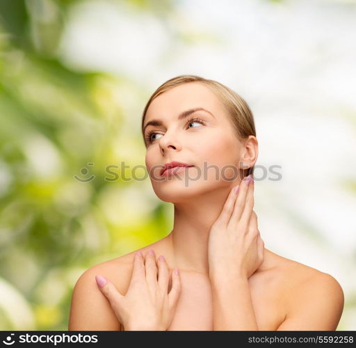 health and beauty concept - face and hands of beautiful woman