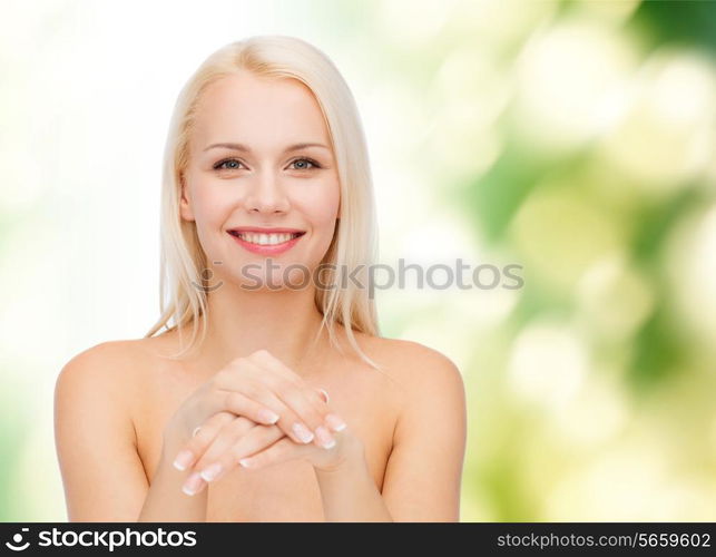 health and beauty concept - face and hands of beautiful woman