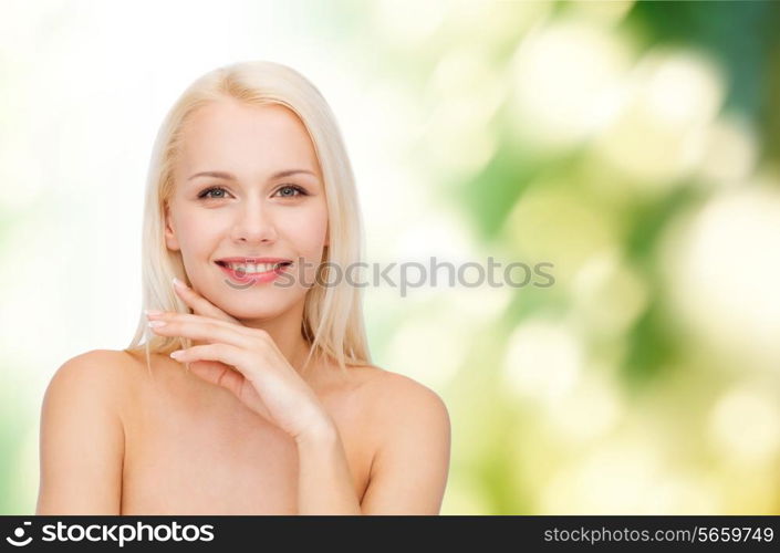 health and beauty concept - face and hands of beautiful woman