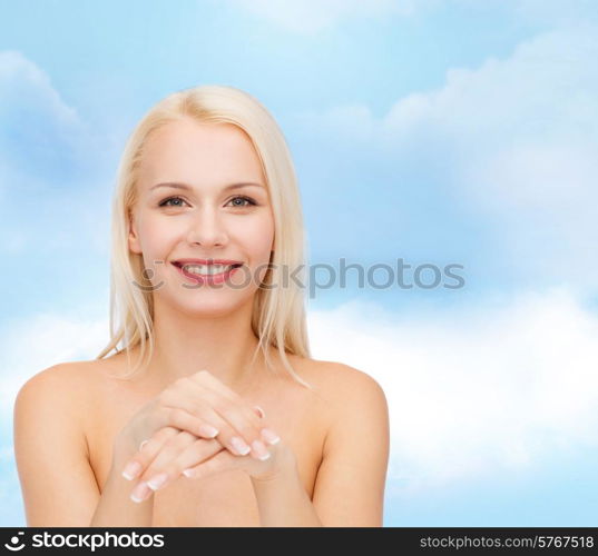 health and beauty concept - face and hands of beautiful woman