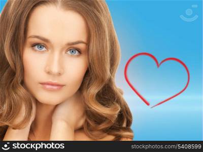 health and beauty concept - face and hands of beautiful woman with long hair over blue background