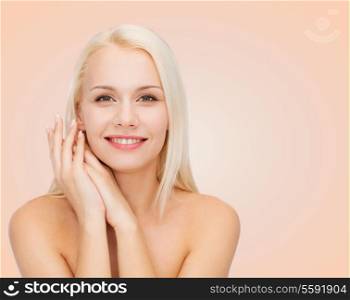 health and beauty concept - face and hands of happy woman