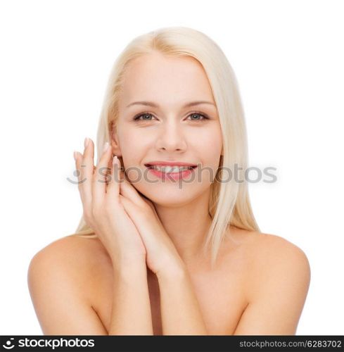 health and beauty concept - face and hands of happy woman