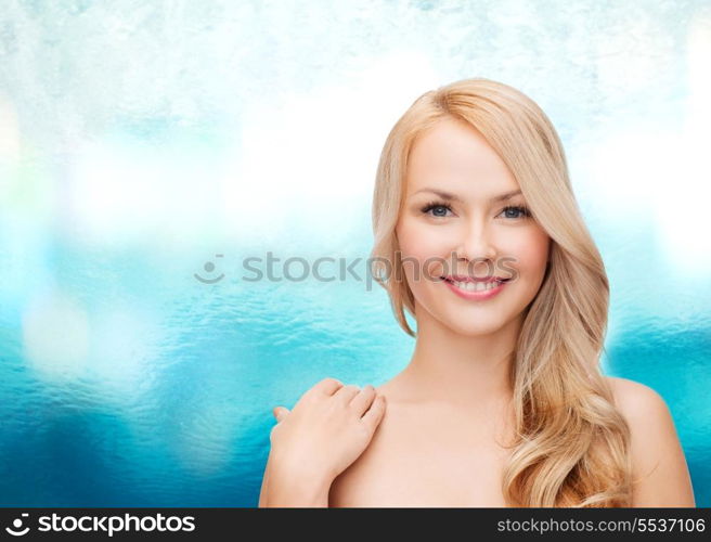 health and beauty concept - face and shoulders of happy woman with long hair