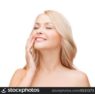health and beauty concept - face of beautiful woman touching her cheek with closed eyes