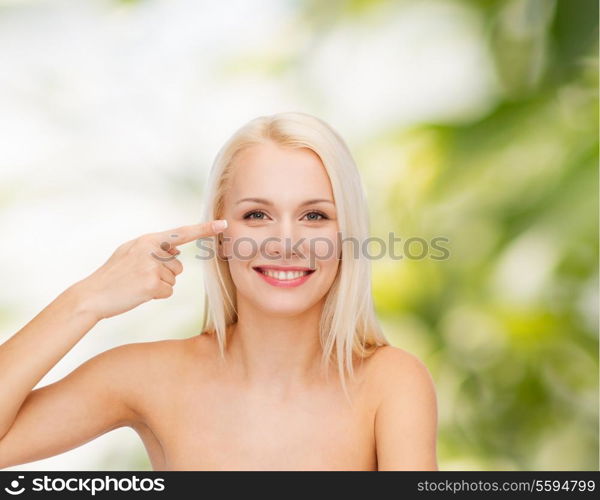 health and beauty concept - face of beautiful woman touching her eye area