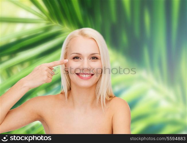 health and beauty concept - face of beautiful woman touching her eye area
