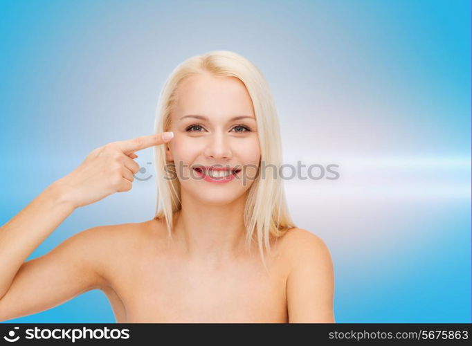 health and beauty concept - face of beautiful woman touching her eye area