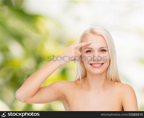 health and beauty concept - face of beautiful woman touching her forehead