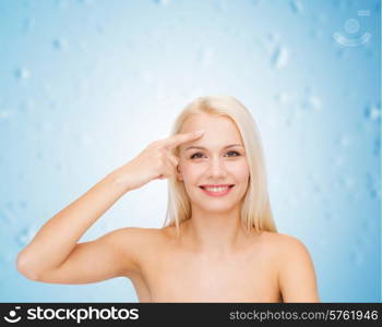 health and beauty concept - face of beautiful woman touching her forehead