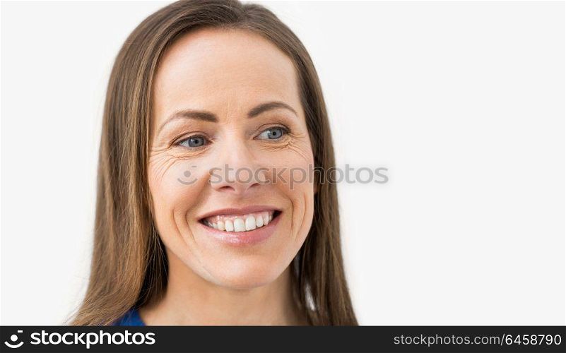health and beauty concept - face of happy smiling middle aged woman. face of happy smiling middle aged woman