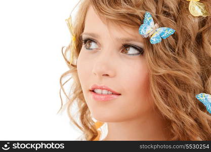 health and beauty concept - happy teenage girl with butterflies in hair