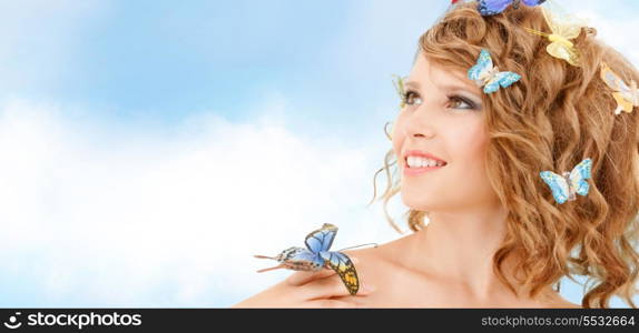 health and beauty concept - happy teenage girl with butterflies in hair and one sitting on her hand