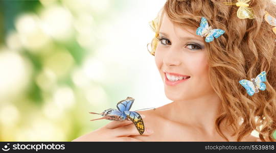 health and beauty concept - happy teenage girl with butterflies in hair and one sitting on her hand