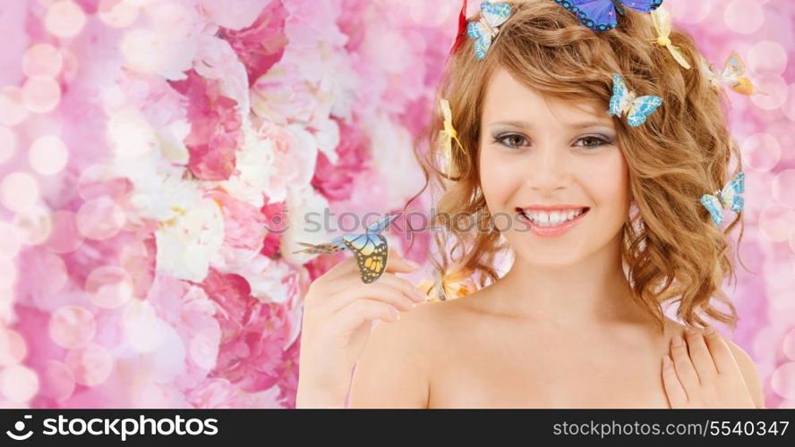 health and beauty concept - happy teenage girl with butterflies in hair and one sitting on her hand