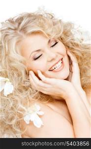 health and beauty concept - happy woman with flowers in hair