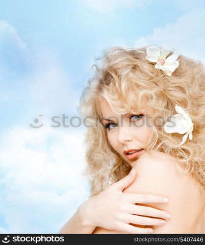 health and beauty concept - happy woman with flowers in hair