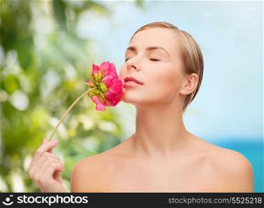 health and beauty concept - lovely woman with pink peony flower and closed eyes