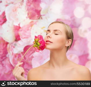 health and beauty concept - lovely woman with pink peony flower and closed eyes