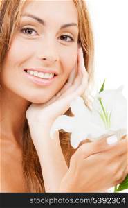 health and beauty concept - lovely woman with white lily flower