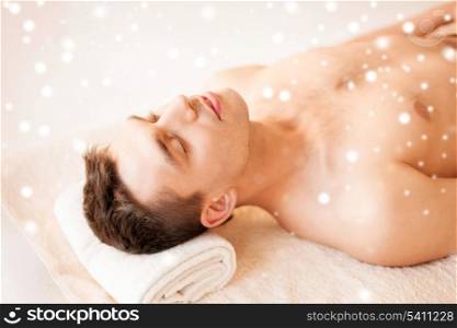health and beauty concept - man in spa salon