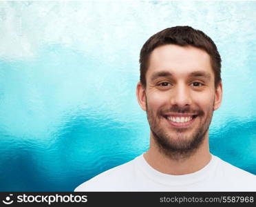 health and beauty concept - portrait of smiling young handsome man