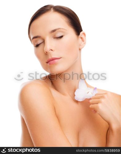 health and beauty concept - relaxed woman with orchid flower. relaxed woman with orchid flower