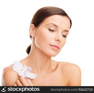 health and beauty concept - relaxed woman with orhid flower. relaxed woman with orhid flower