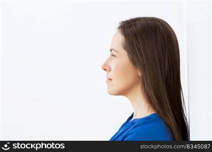 health and beauty concept - side view of beautiful middle aged woman face. face of happy smiling middle aged woman