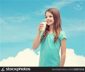 health and beauty concept - smiling little girl drinking milk out of glass