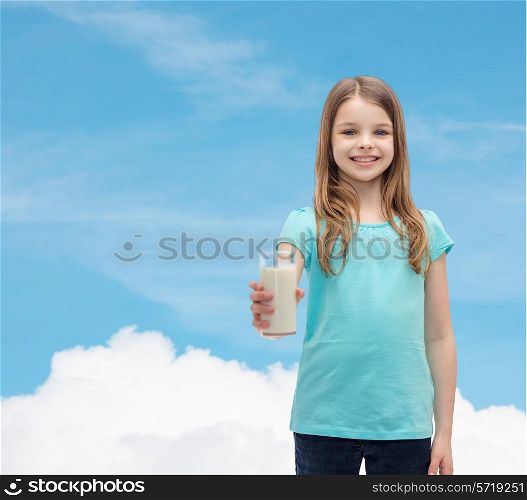 health and beauty concept - smiling little girl giving glass of milk