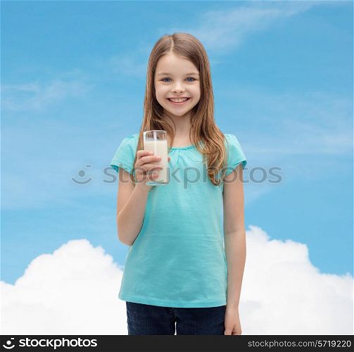 health and beauty concept - smiling little girl with glass of milk