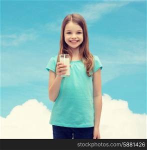 health and beauty concept - smiling little girl with glass of milk