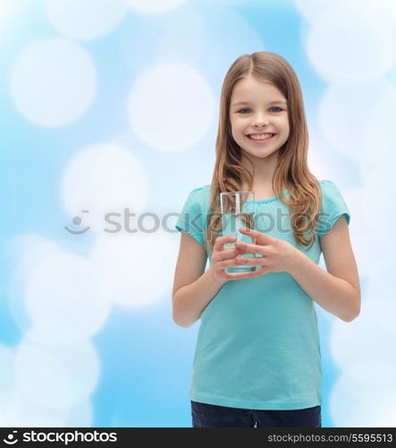 health and beauty concept - smiling little girl with glass of water