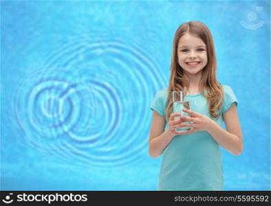 health and beauty concept - smiling little girl with glass of water