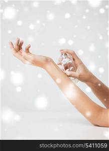 health and beauty concept - woman hands spraying perfume