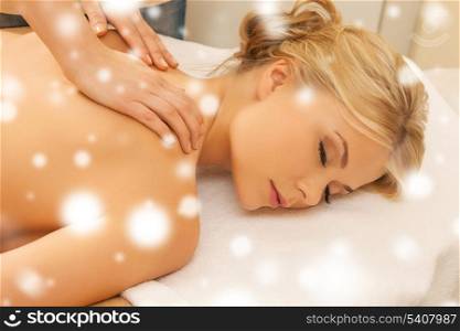 health and beauty concept - woman in spa salon getting massage