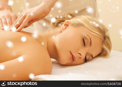 health and beauty concept - woman in spa salon getting massage