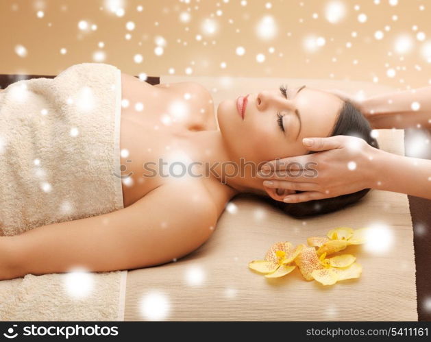 health and beauty concept - woman in spa salon lying on the massage desk