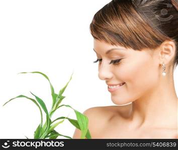 health and beauty concept - woman with green sprout
